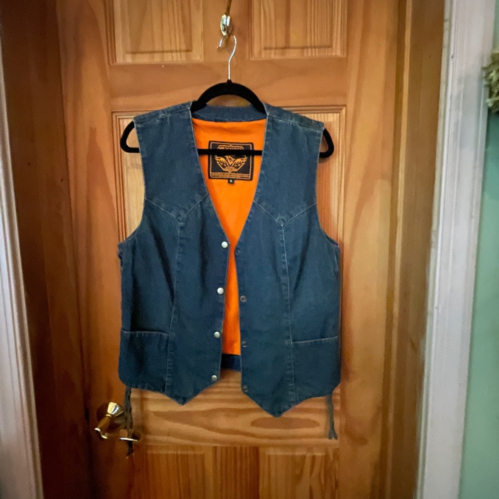 Great denim vest with snap front and tie on sides.